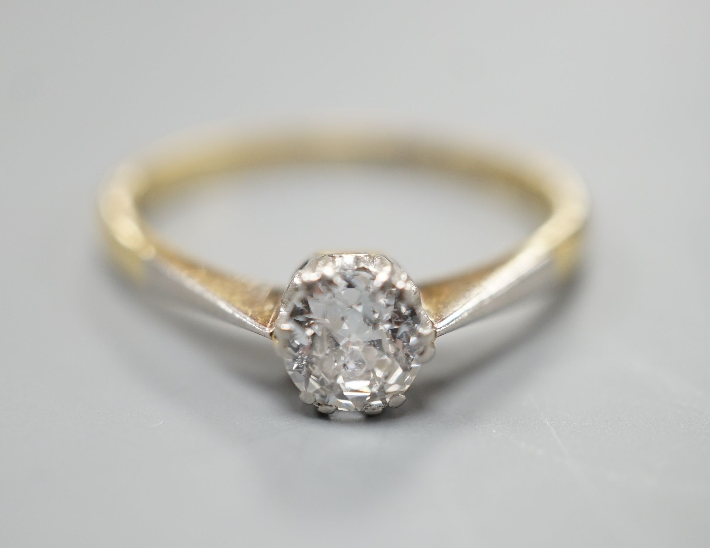 An 18ct gold and platinum solitaire diamond ring, the brilliant cut stone approximately 0.35cts, size M, gross 2.5 grams